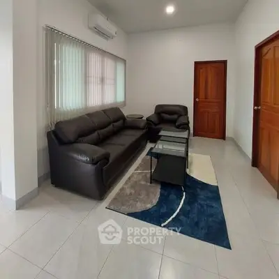 Spacious living room with modern leather sofas and stylish decor