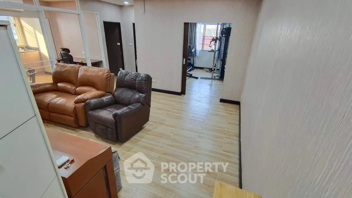 Spacious living room with modern furniture and wooden flooring