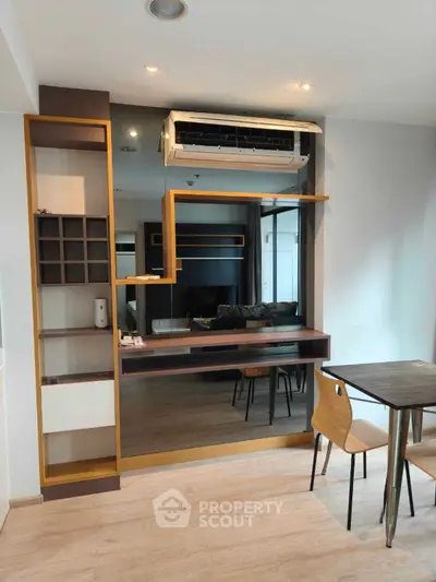 Modern study area with sleek desk and wall-mounted air conditioner in stylish apartment.
