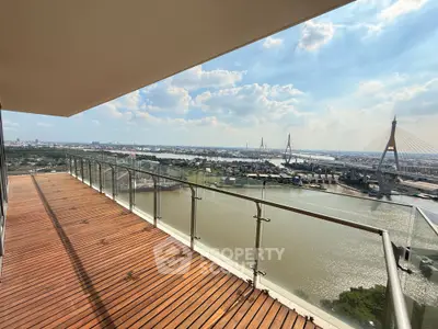 Stunning balcony view overlooking river and cityscape with modern railing.