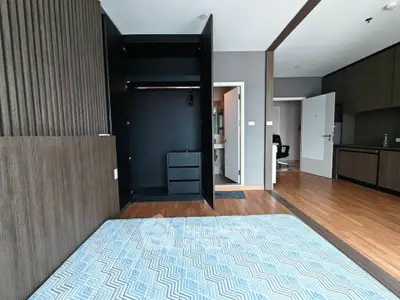 Modern bedroom with open closet and wooden flooring in a stylish apartment