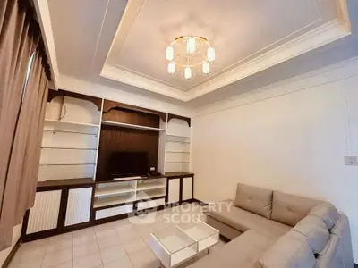 Elegant living room with modern chandelier and cozy sectional sofa