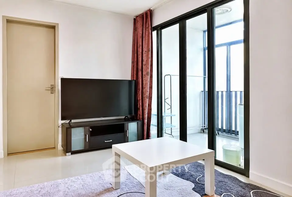Modern living room with balcony access and sleek TV setup