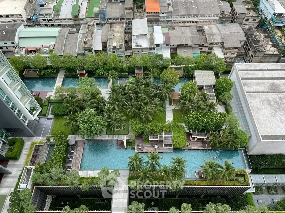Luxurious rooftop garden with swimming pool offering stunning city views in a modern residential complex.