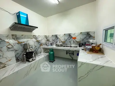 Modern kitchen with marble backsplash and gas stove