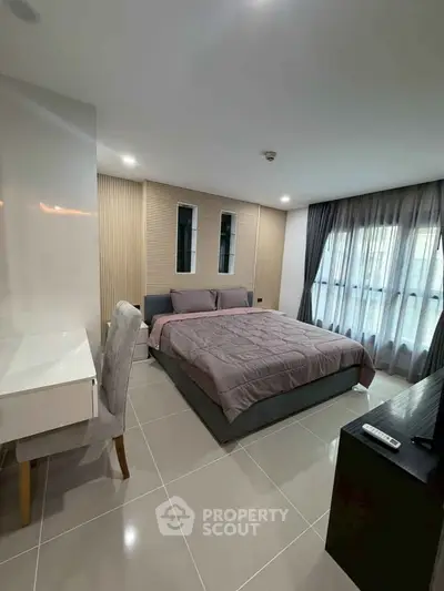 Modern bedroom with sleek design, featuring a cozy bed, stylish desk, and large windows for natural light.