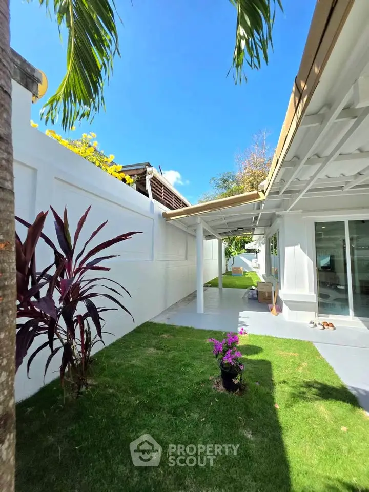 Charming outdoor garden area with lush greenery and modern exterior design, perfect for relaxation and entertaining.