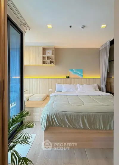 Modern bedroom with cozy decor and natural light, featuring a large bed and stylish wooden accents.