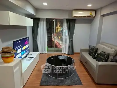 Modern living room with sleek furniture and city view from balcony.