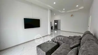 Spacious modern living room with sleek design and wall-mounted TV
