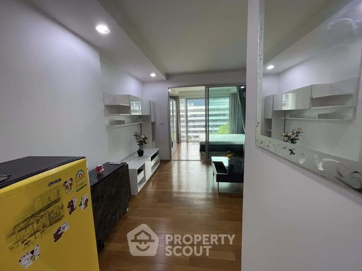 Modern apartment interior with wooden flooring and balcony view