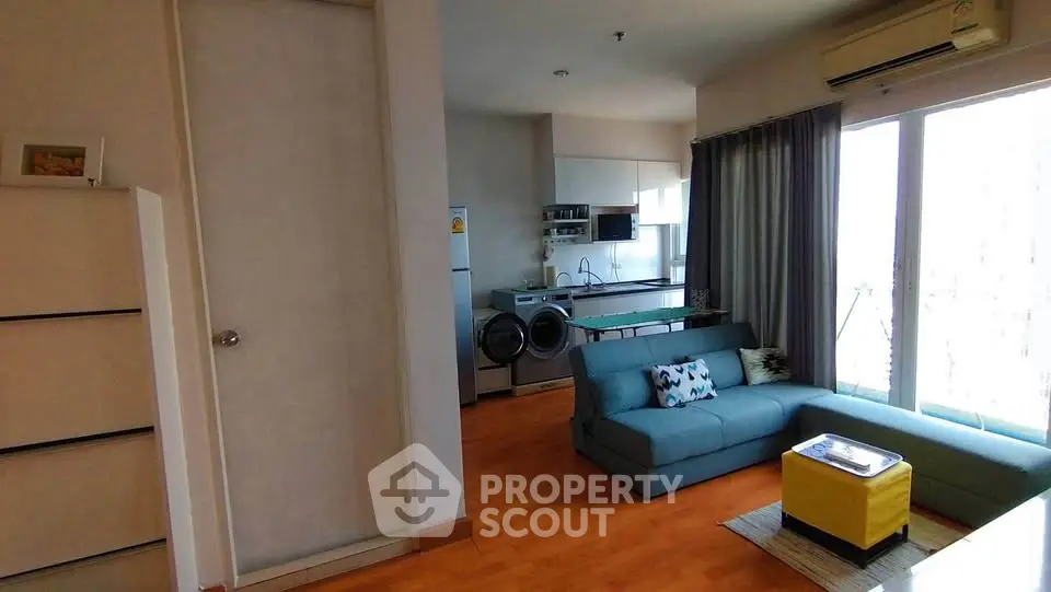 Modern living room with open kitchen and stylish furniture in a bright apartment.