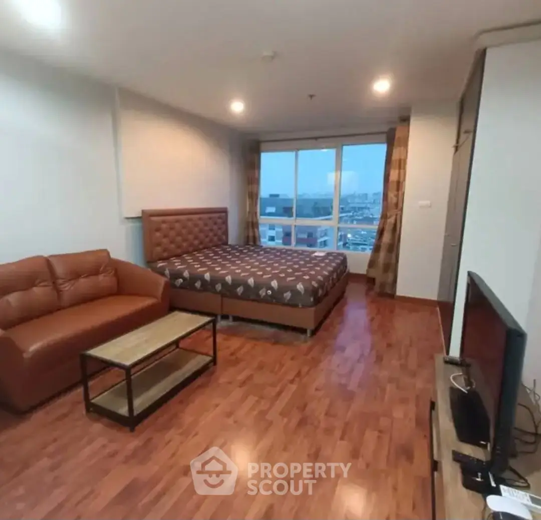 Spacious studio apartment with cozy living area and city view