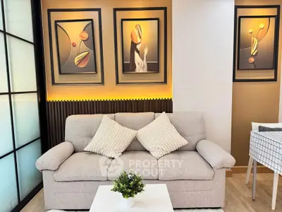 Stylish living room with modern art and cozy sofa, perfect for relaxation.