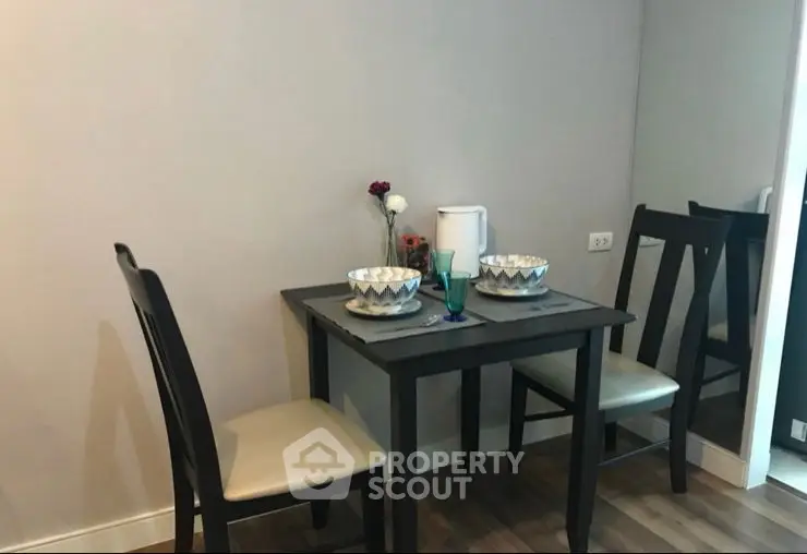 Modern dining area with elegant table setting and stylish chairs in a cozy apartment.