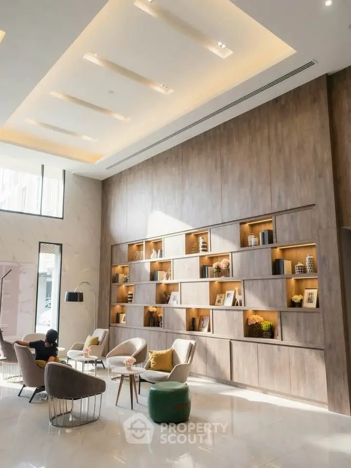 Luxurious modern lobby with elegant seating and decorative shelving, perfect for welcoming guests.