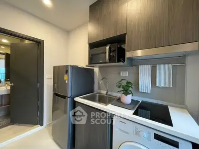 Modern compact kitchen with appliances and stylish cabinetry