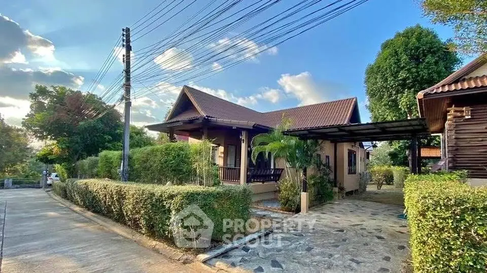 Charming single-story house with lush garden and carport in serene neighborhood.