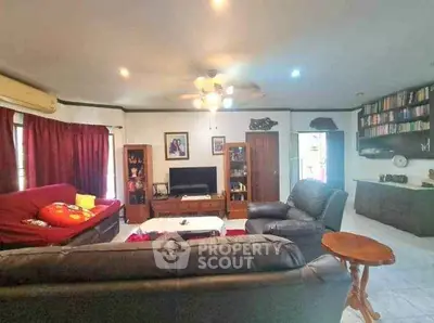 Spacious living room with cozy seating and entertainment center