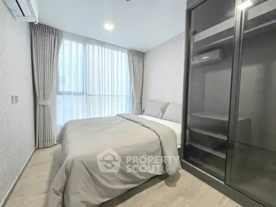 Modern bedroom with sleek design and large window for natural light