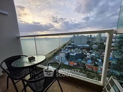 Stunning high-rise balcony with panoramic ocean and city views, perfect for relaxation and entertainment.