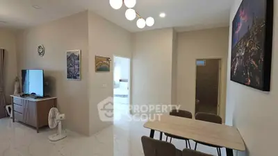 Modern living room with dining area, stylish decor, and natural lighting in a contemporary apartment.