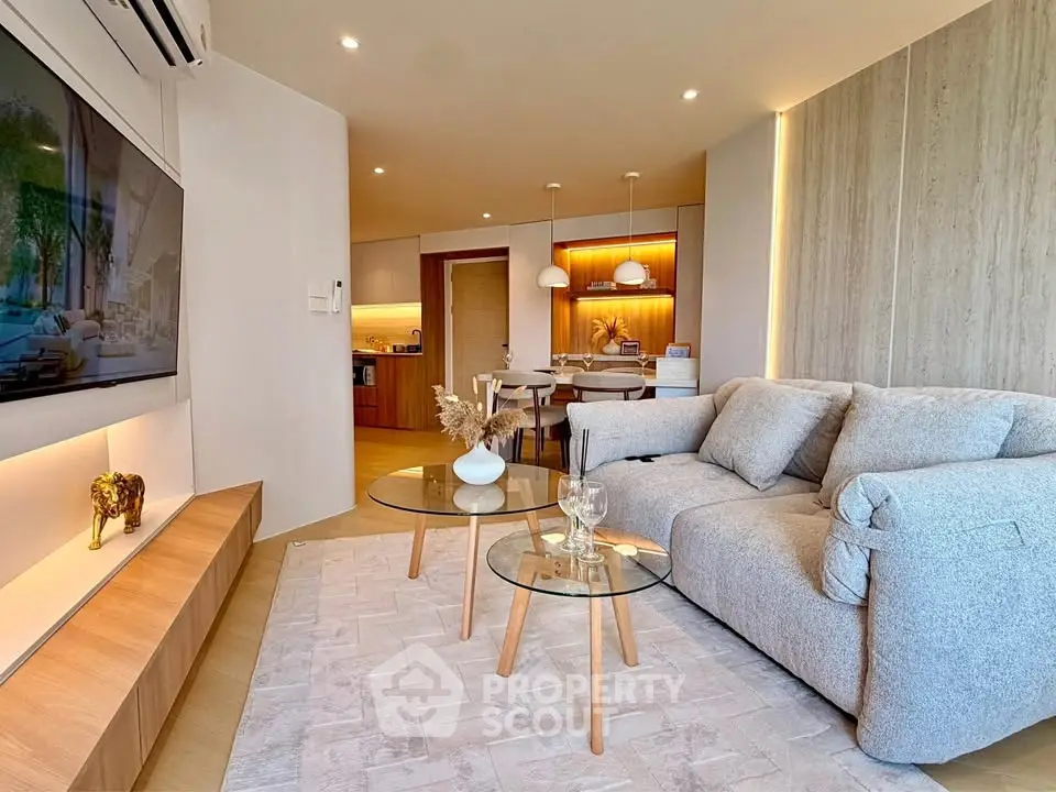 Modern living room with cozy sofa and stylish decor in open layout apartment.