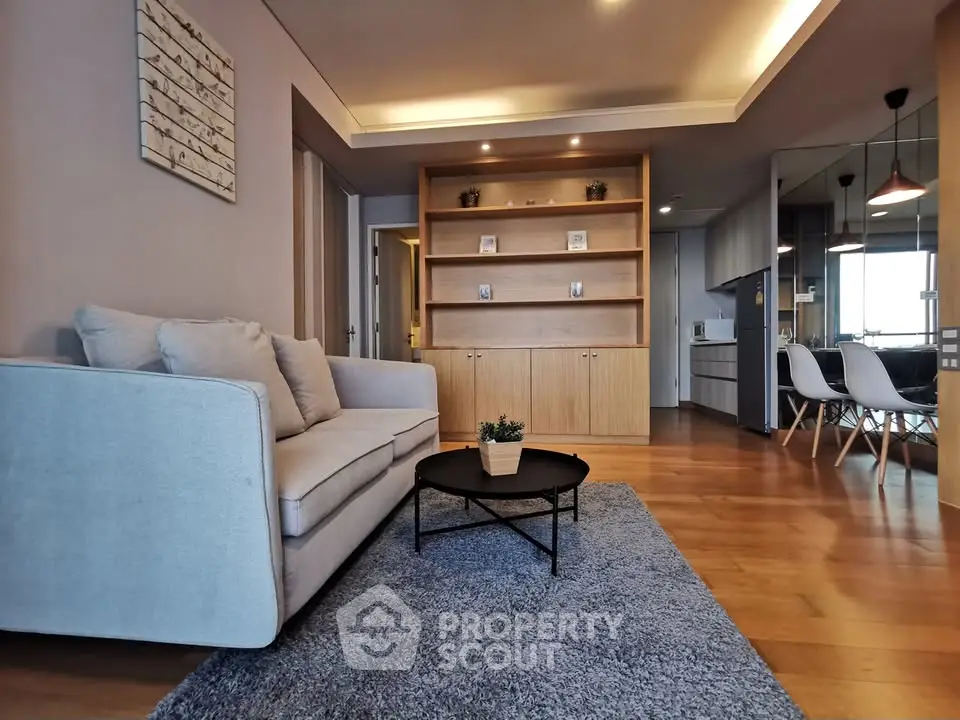 Modern living room with cozy sofa and stylish decor in open layout apartment.