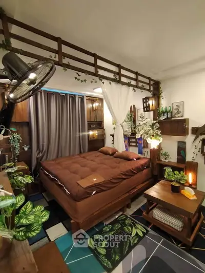 Cozy bedroom with lush greenery and warm lighting, featuring a comfortable bed and stylish decor.