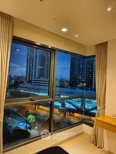 Stunning corner unit with panoramic city view from large windows, perfect for urban living.