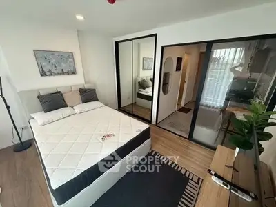 Modern bedroom with mirrored closet and stylish decor in a cozy apartment.