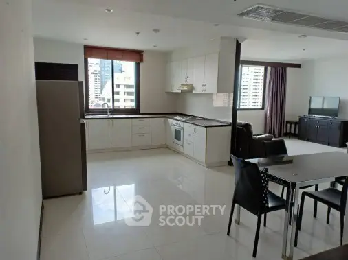 Spacious open-plan kitchen and living area with modern appliances and city view.