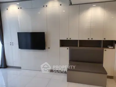 Modern living room with sleek built-in storage and mounted TV, elegant design