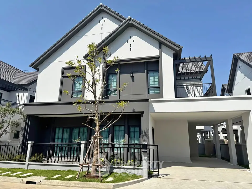 Modern two-story house with sleek design and spacious carport in a sunny neighborhood.
