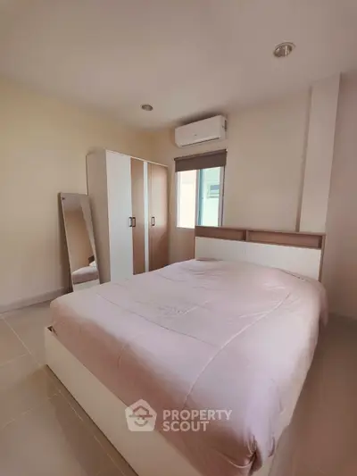 Cozy bedroom with modern furniture and air conditioning, perfect for relaxation and comfort.