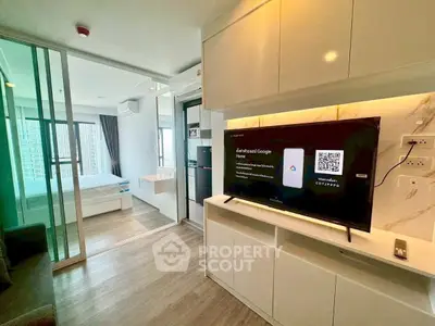 Modern apartment interior with open layout, featuring a cozy living area and a glimpse of the bedroom.