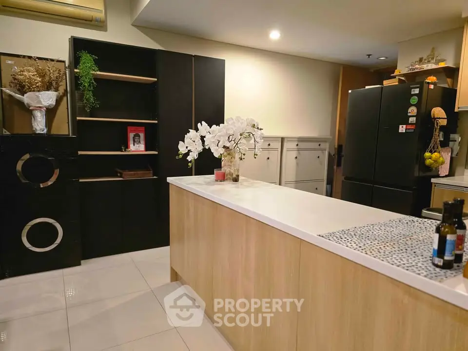 Modern kitchen with sleek black appliances and elegant white countertop