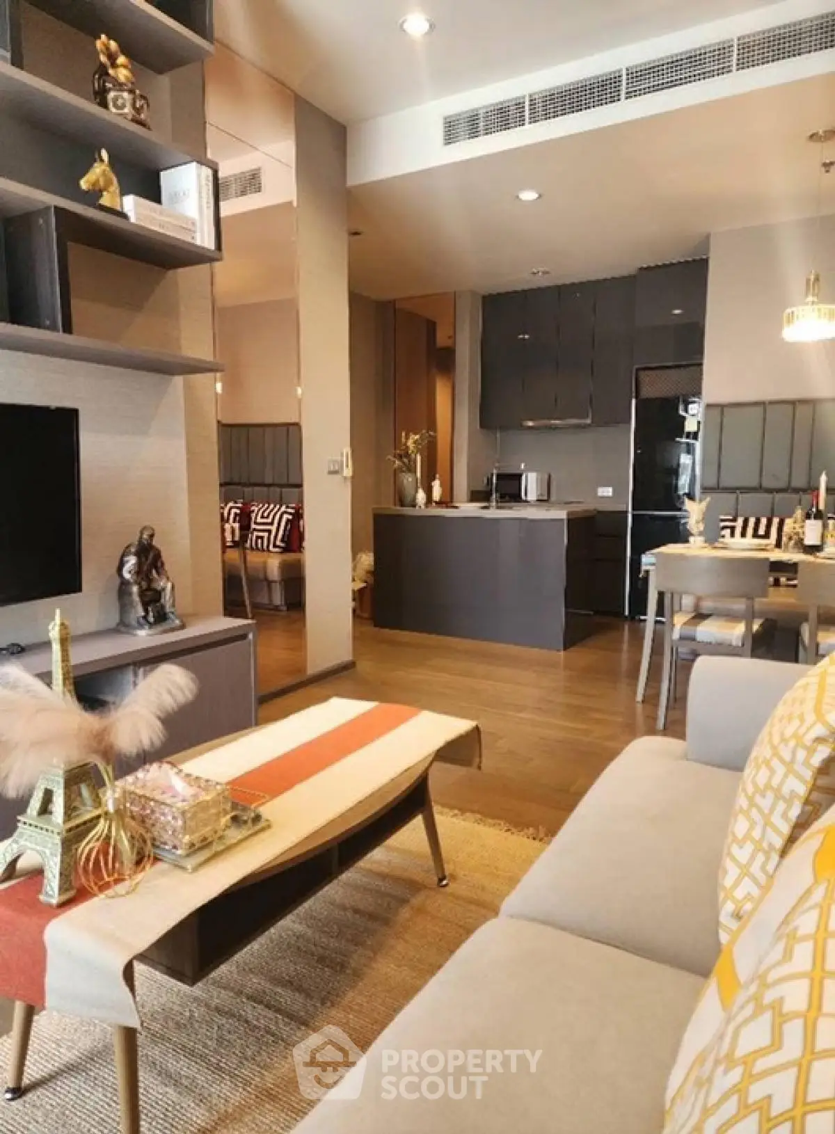 Modern open-plan living room with stylish kitchen and cozy decor