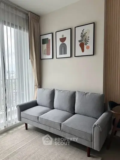 Stylish modern living room with gray sofa and abstract art decor