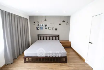 Spacious bedroom with modern decor and ample natural light