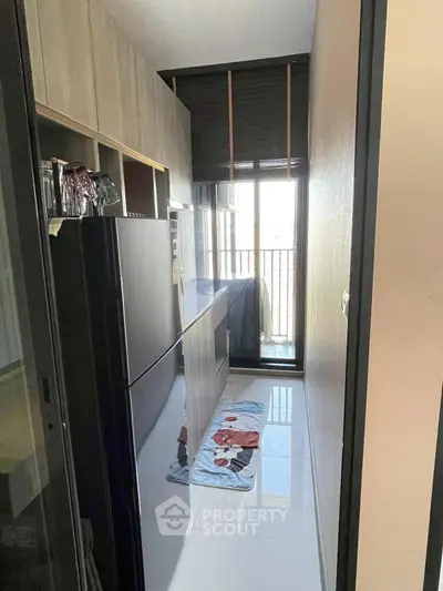 Modern kitchen with sleek appliances and balcony view, perfect for urban living.