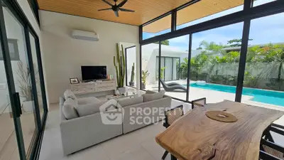 Luxurious living room with pool view and modern decor in tropical setting