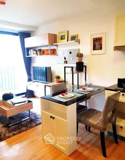 Modern living room with stylish decor and open kitchen layout in a cozy apartment.