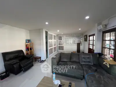 Spacious living room with modern furniture and ample natural light