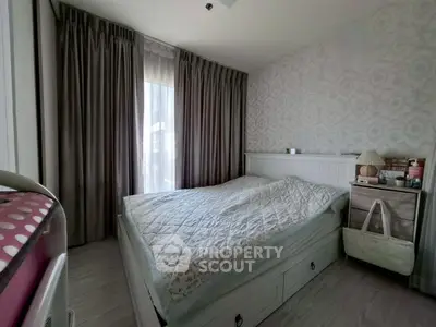 Cozy bedroom with elegant decor and ample natural light, featuring a comfortable bed and stylish furnishings.
