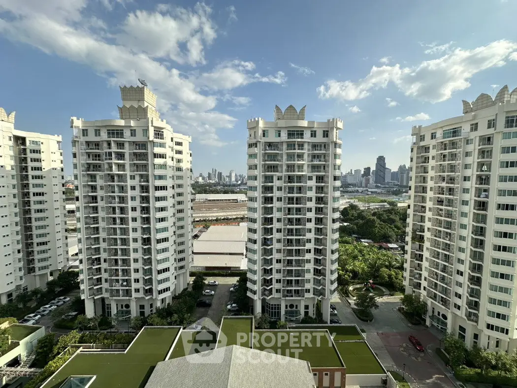 Stunning high-rise apartment buildings with city skyline view, perfect for urban living.