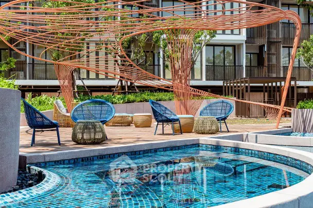 Luxurious modern apartment complex with stylish outdoor pool and seating area.