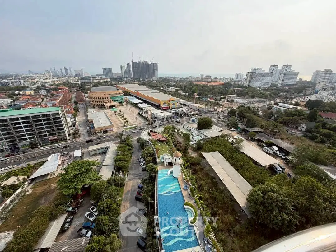 Stunning aerial view of urban landscape with pool and city skyline, perfect for real estate investment.