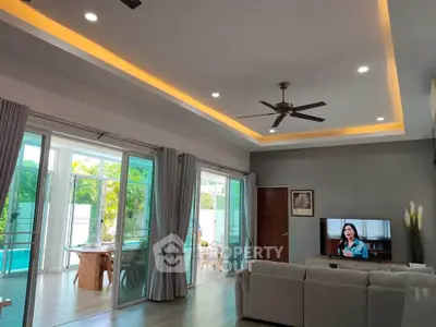 Spacious living room with pool view and modern decor