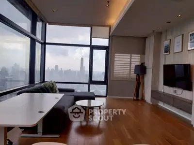 Stunning modern living room with panoramic city views and sleek furnishings.